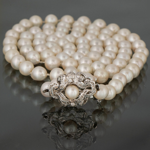 Collar de perlas cultivadas de 0,5cm con broche en oro blanco de 18kt con perla central y brillantes.