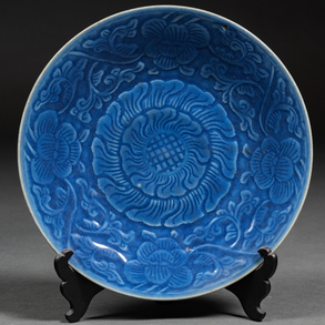 Chinese porcelain circular dish in blue color with lotus flower decoration of the nineteenth century.