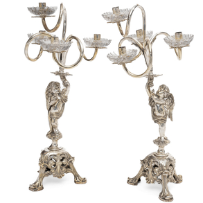 Pair of Louis XV style silver plated metal candlesticks of four lights, 20th century.