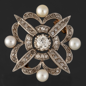 Antique star-shaped brooch in yellow gold with old-cut diamonds and four pearls.