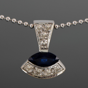 18kt white gold choker in the shape of balls with a pendant of diamonds and a marquise cut sapphire.