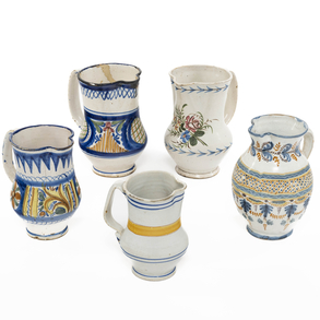 A set of five glazed ceramic jugs with 19th-20th century floral decoration.